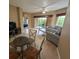 Open living room with dining area and access to balcony at 8801 Worldquest Blvd # 4203, Orlando, FL 32821