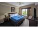 A well-appointed primary bedroom featuring a comfortable bed, TV, and ample natural light at 8801 Worldquest Blvd # 4203, Orlando, FL 32821