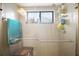 Modern walk-in shower features a sleek glass enclosure, built-in shelving, and updated shower head and fixtures at 97 Hillside Dr, Eustis, FL 32726
