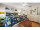 Bedroom features wood floors, ceiling fan, neutral walls, large dresser, and bright light from the window at 97 Hillside Dr, Eustis, FL 32726