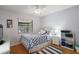 Nautical themed bedroom features wood flooring, a ceiling fan, and a window for natural light at 97 Hillside Dr, Eustis, FL 32726