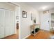 Bright foyer featuring a decorative table, wood flooring, and a well-lit entryway at 97 Hillside Dr, Eustis, FL 32726