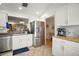 Bright kitchen features white cabinetry, stainless steel appliances, tile flooring and a butcher block countertop at 97 Hillside Dr, Eustis, FL 32726