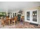 Covered patio featuring a dining set, ceiling fans, and seamless access to the pool area at 97 Hillside Dr, Eustis, FL 32726