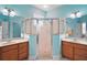 Bright bathroom featuring dual vanities, a glass-enclosed shower, and modern fixtures at 971 Caribou Way, The Villages, FL 32162