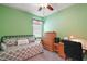 Cozy bedroom with a daybed, wooden dresser, and a dedicated workspace area at 971 Caribou Way, The Villages, FL 32162