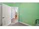 Guest bedroom with light green walls and an en suite bathroom at 971 Caribou Way, The Villages, FL 32162