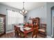 Charming dining room with a wooden table, seating for six, and a decorative chandelier at 971 Caribou Way, The Villages, FL 32162