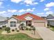 Charming single-story home with a well-manicured lawn and a two-car garage at 971 Caribou Way, The Villages, FL 32162