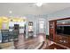 Open-concept living room featuring hardwood floors, modern lighting, and seamless kitchen access at 971 Caribou Way, The Villages, FL 32162