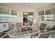 Relaxing porch with outdoor furniture, checkerboard and view of the backyard at 971 Caribou Way, The Villages, FL 32162