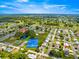 Community aerial view showcases amenities like tennis courts, ponds and landscaping in this established neighborhood at 9773 Se 179Th Pl, Summerfield, FL 34491
