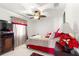 Bright bedroom featuring a ceiling fan, neutral walls, carpet and a comfortable bed with bright floral arrangement at 9773 Se 179Th Pl, Summerfield, FL 34491