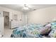Bedroom featuring a floral-patterned bed, white furniture, carpeted floor and walk-in closet at 9773 Se 179Th Pl, Summerfield, FL 34491