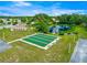 Overhead view of the bocce ball courts, landscaped with benches and a picturesque pond and gazebo at 9773 Se 179Th Pl, Summerfield, FL 34491