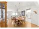 Open-concept dining area with wood floors, stylish lighting and seamless flow to the kitchen and living spaces at 9773 Se 179Th Pl, Summerfield, FL 34491