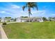 A well-maintained lawn and landscaping highlight this single-story home with a 2 car garage at 9773 Se 179Th Pl, Summerfield, FL 34491