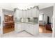 Cozy kitchen featuring white cabinets, granite countertops, stylish backsplash and tile flooring creating a warm ambiance at 9773 Se 179Th Pl, Summerfield, FL 34491
