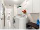 A well-equipped laundry room with a washer, dryer, and storage cabinets at 9773 Se 179Th Pl, Summerfield, FL 34491