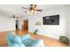 Cozy living room boasts wood floors and a comfortable recliner, perfect for relaxing or watching television at 9773 Se 179Th Pl, Summerfield, FL 34491