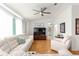 Bright living room with light-colored walls, neutral-toned furniture, and wood laminate flooring at 9773 Se 179Th Pl, Summerfield, FL 34491