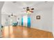 Bright living room featuring wood floors, ceiling fans, and a comfortable seating area creating a welcoming space at 9773 Se 179Th Pl, Summerfield, FL 34491