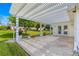 Outdoor patio featuring an open pergola, stone flooring, and landscaping perfect for entertaining or enjoying the outdoors at 9773 Se 179Th Pl, Summerfield, FL 34491