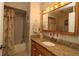 Bright bathroom featuring granite countertops and a shower-tub combination at 9948 Se 175Th Pl, Summerfield, FL 34491