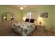 Cozy bedroom featuring floral bedding, matching nightstands, and plenty of natural light at 9948 Se 175Th Pl, Summerfield, FL 34491