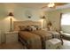 Spacious bedroom featuring a large bed, two nightstands with lamps, and neutral decor at 9948 Se 175Th Pl, Summerfield, FL 34491