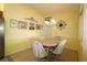 Cozy dining area with a chandelier and seating for four at 9948 Se 175Th Pl, Summerfield, FL 34491