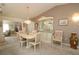 Elegant dining area with a stylish chandelier, display cabinet, and seating for six at 9948 Se 175Th Pl, Summerfield, FL 34491
