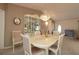 Formal dining room featuring a chandelier, display cabinet, and elegant seating at 9948 Se 175Th Pl, Summerfield, FL 34491