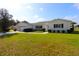 Charming single-story residence with a lush green lawn and neatly trimmed hedges, offering a welcoming appeal at 9948 Se 175Th Pl, Summerfield, FL 34491