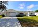 Well-maintained single-story home featuring an attached garage and an attractive decorative concrete driveway at 9948 Se 175Th Pl, Summerfield, FL 34491