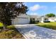 Charming single Gathering home with a large driveway, manicured lawn, and inviting curb appeal at 9948 Se 175Th Pl, Summerfield, FL 34491