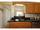 Pass-through kitchen with granite countertops and wood cabinets at 9948 Se 175Th Pl, Summerfield, FL 34491