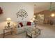 Inviting living room with a comfortable sofa, decorative wall art, and access to the dining area at 9948 Se 175Th Pl, Summerfield, FL 34491