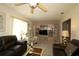 Inviting living room with comfortable seating and a large entertainment center at 9948 Se 175Th Pl, Summerfield, FL 34491