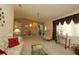 Spacious living area featuring comfortable seating, decorative lighting, and access to the dining area at 9948 Se 175Th Pl, Summerfield, FL 34491