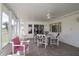 Sunroom features tile floors, a ceiling fan, and white furniture, with views of the outdoors at 9948 Se 175Th Pl, Summerfield, FL 34491