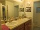 Bathroom with double sinks, ample counter space, and a framed mirror for a functional design at 1010 Chelsea Dr, Davenport, FL 33897