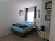 The bedroom features a bed, a window with curtains, and artwork on the walls at 1010 Chelsea Dr, Davenport, FL 33897