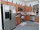 Well-lit kitchen with stainless steel appliances, plentiful cabinet storage, and efficient layout at 1010 Chelsea Dr, Davenport, FL 33897