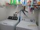 Laundry room with a washer, dryer, and overhead shelving for storage at 1010 Chelsea Dr, Davenport, FL 33897