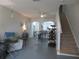 Open living space with stairs, a ceiling fan, neutral walls and a bar area with seating at 1010 Chelsea Dr, Davenport, FL 33897