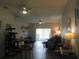 Spacious living area with an open floor plan, ceiling fans, and a dining set, perfect for entertaining at 1010 Chelsea Dr, Davenport, FL 33897