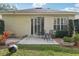 Patio and backyard with seating area and mature trees at 1022 Saint Ives Ct, Mount Dora, FL 32757