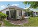 Landscaped backyard with patio and mature shrubbery at 1022 Saint Ives Ct, Mount Dora, FL 32757