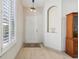 Bright foyer with hardwood floors, a decorative niche, and a view of the front door at 1022 Saint Ives Ct, Mount Dora, FL 32757